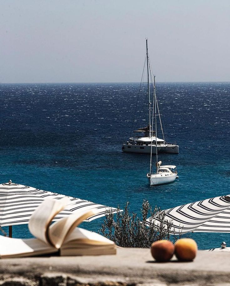 Yachts on the deep blue Aegean seen past a Mykonos beach club